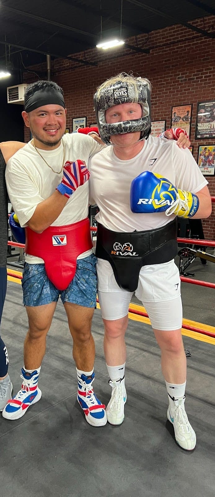 Ryan Basco is in the West End Athletic Club boxing ring with a member ready to sparr.