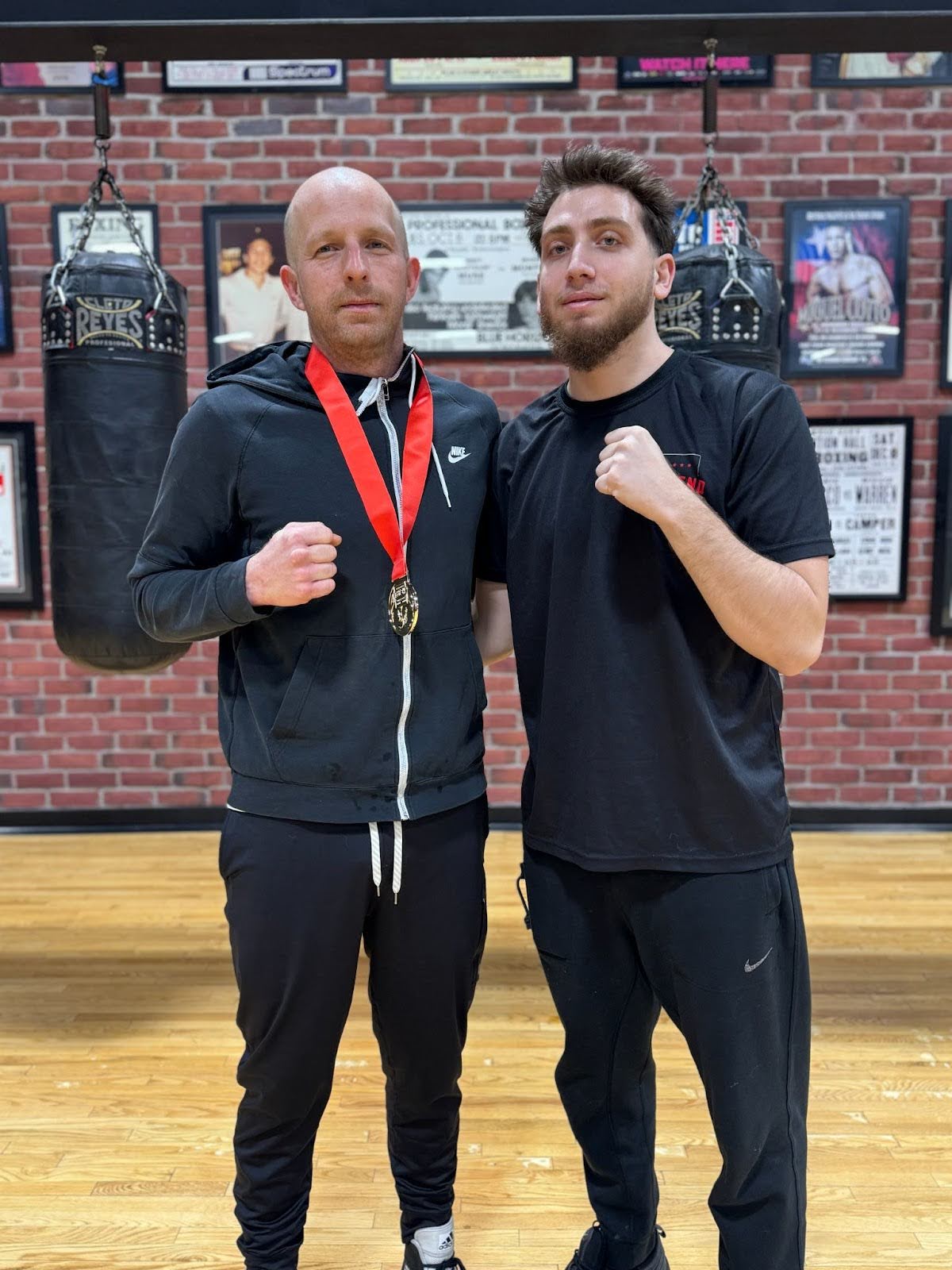 Tommy Glonczi stands beside Dom Williams inside the West End Athletic Club gym in Toronto.