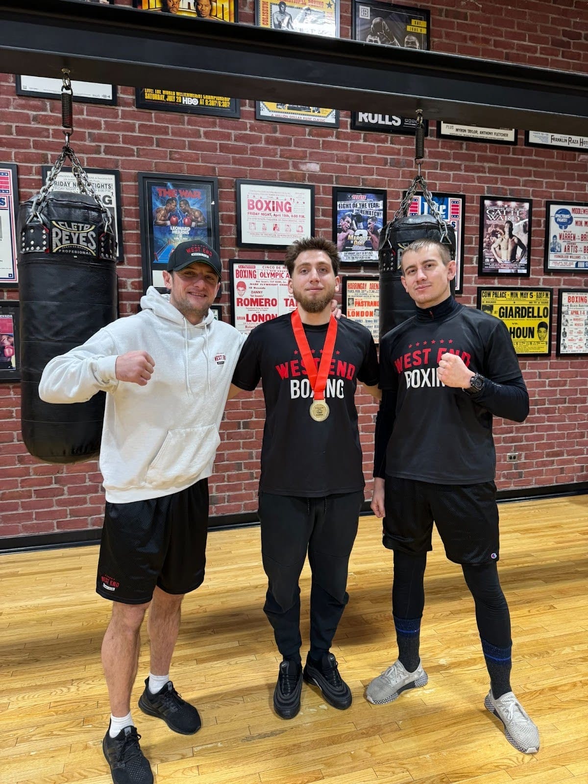 Vinny Cappuccitti is standing on Tommy Glonczi&rsquo;s right side with Jeremy Miazga-Grzybek on his left. They are inside the gym at West End Athletic Club in Toronto.