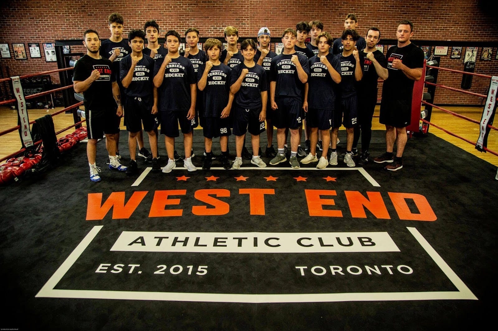 A hockey team standing in the boxing ring at West End AC in Toronto after finishing a sports cross-training session.
